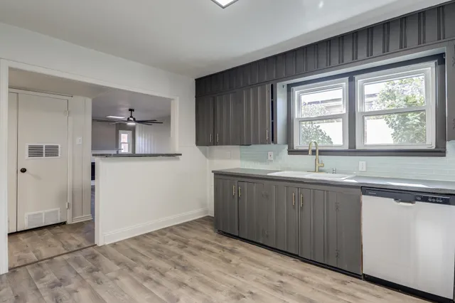 a view of a kitchen with a sink and windows