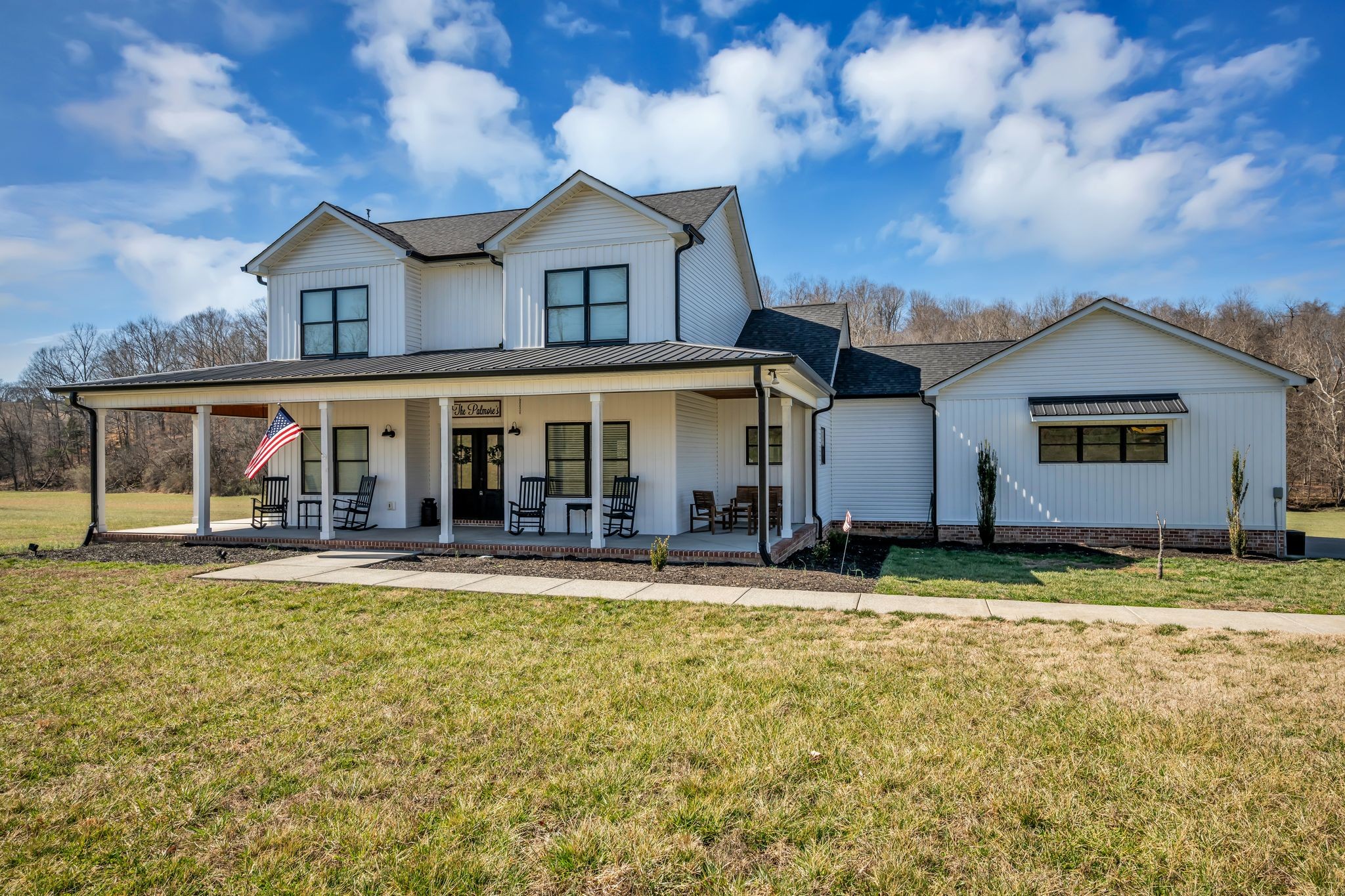 1227 Stayton Road Cumberland Furnace, TN 37051 - Photo 65 of 70 a view of a white house with a large windows and a yard with plants and large trees