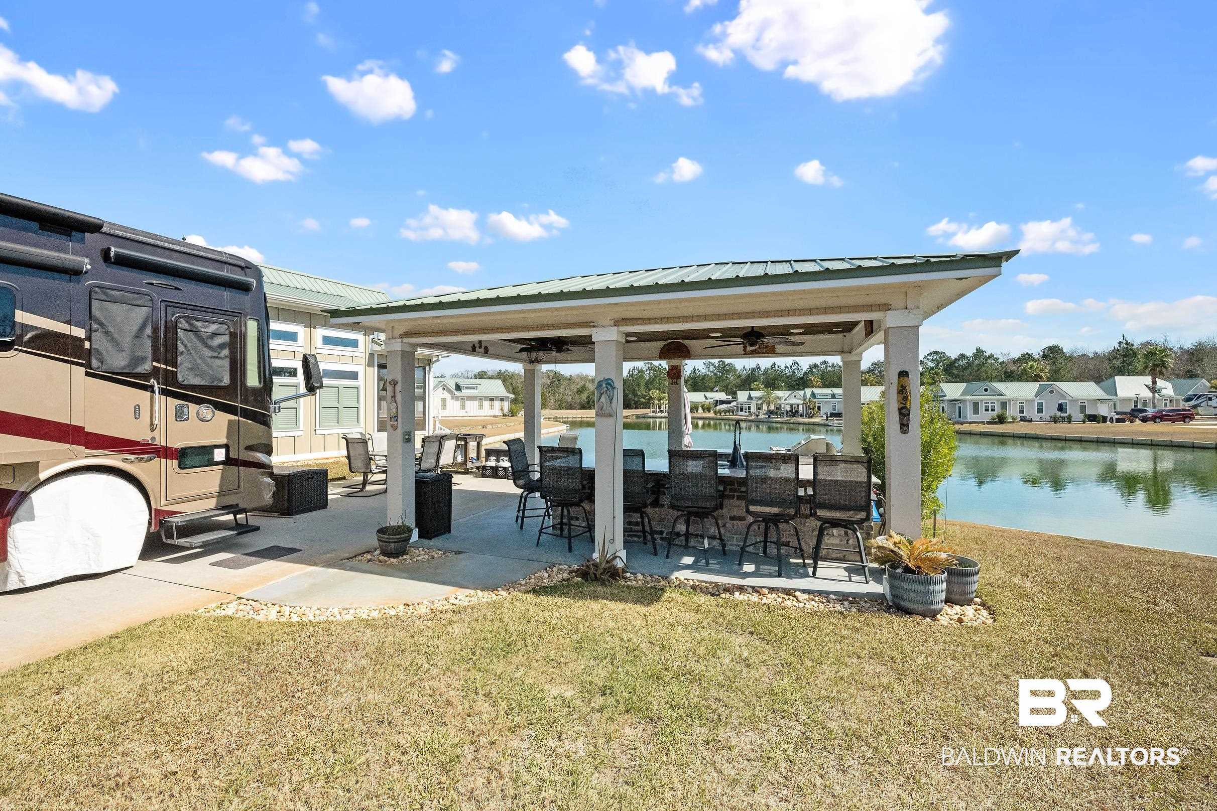 11996 Raptor Court Elberta, AL 36530 - Photo 4 of 45 Dock featuring a patio, a lawn, a gazebo, a water view, and an outdoor bar