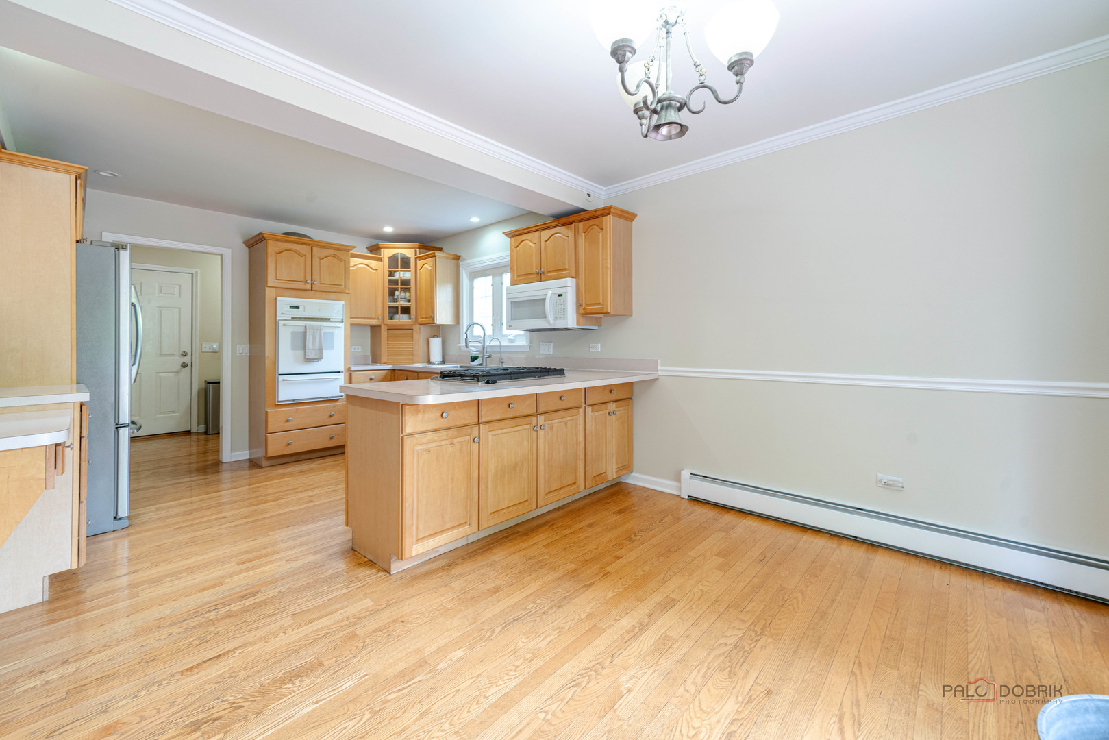 357 Roberts Road Inverness, IL 60010 - Photo 18 of 50 a kitchen with a sink cabinets and wooden floor