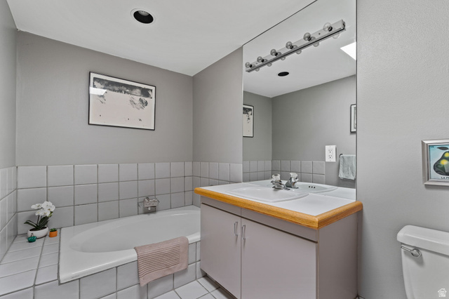 1856 Fort Canyon Road Alpine, UT 84004 - Photo 46 of 49 Bathroom featuring a built-in bathtub, a vanity with a laminate countertop, and an integrated sink