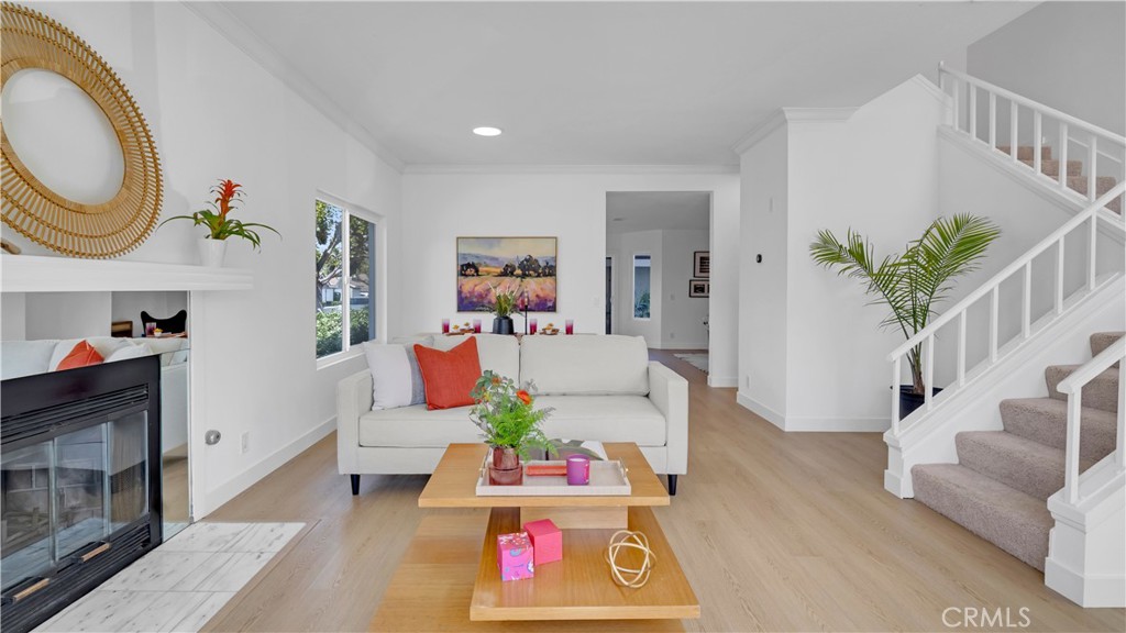 336 Fallingstar Irvine, CA 92614 - Photo 14 of 73 a living room with furniture a fireplace and a potted plant