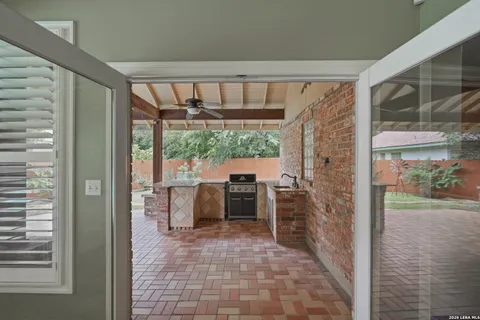 a view of a patio with a dining table and chairs