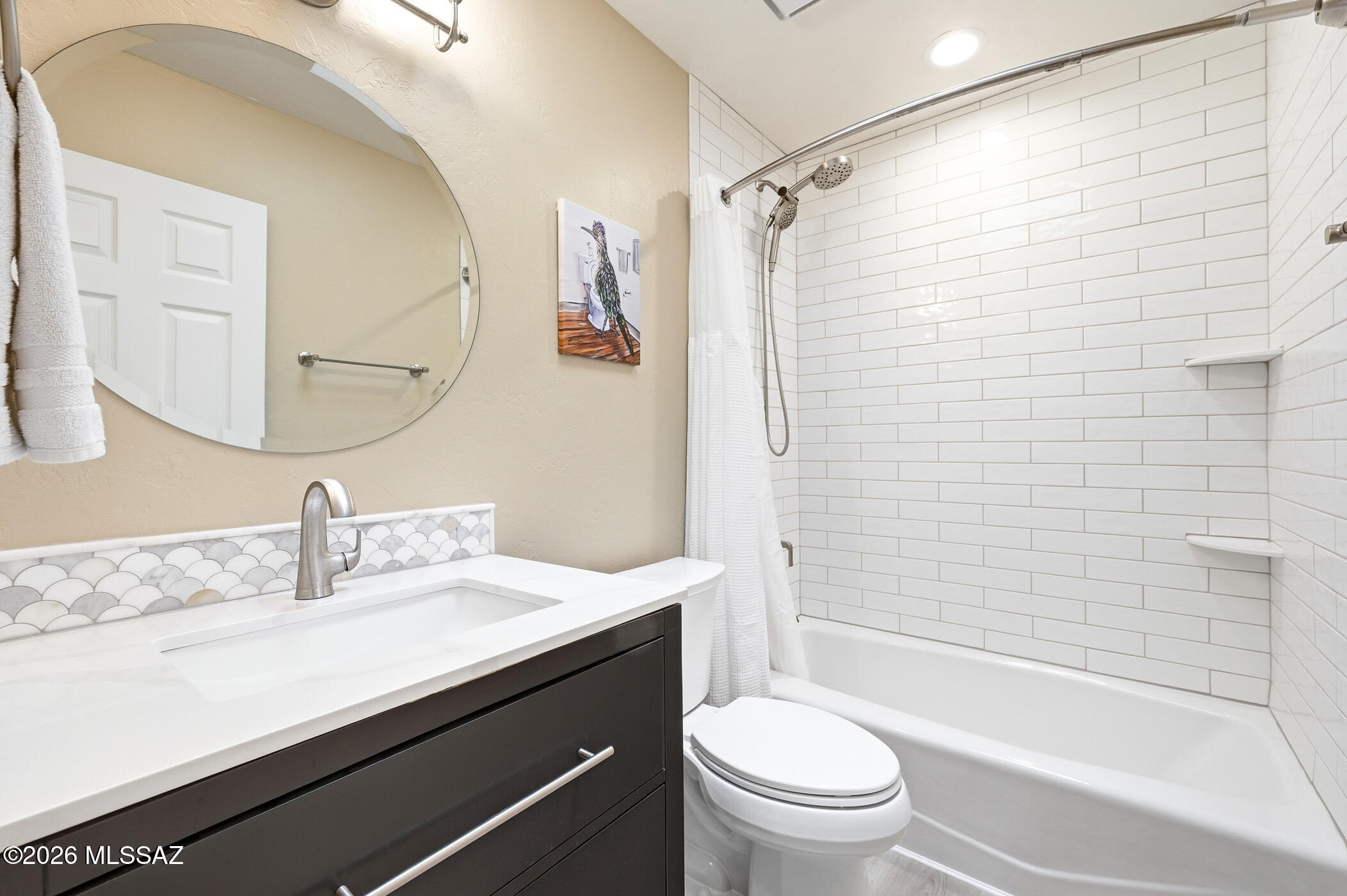 13599 East Rincon Ranch Road Vail, AZ 85641 - Photo 31 of 41 a bathroom with a sink a toilet a mirror a bathtub and shower