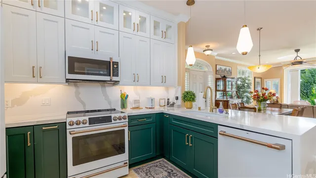 a kitchen with a sink stove and microwave