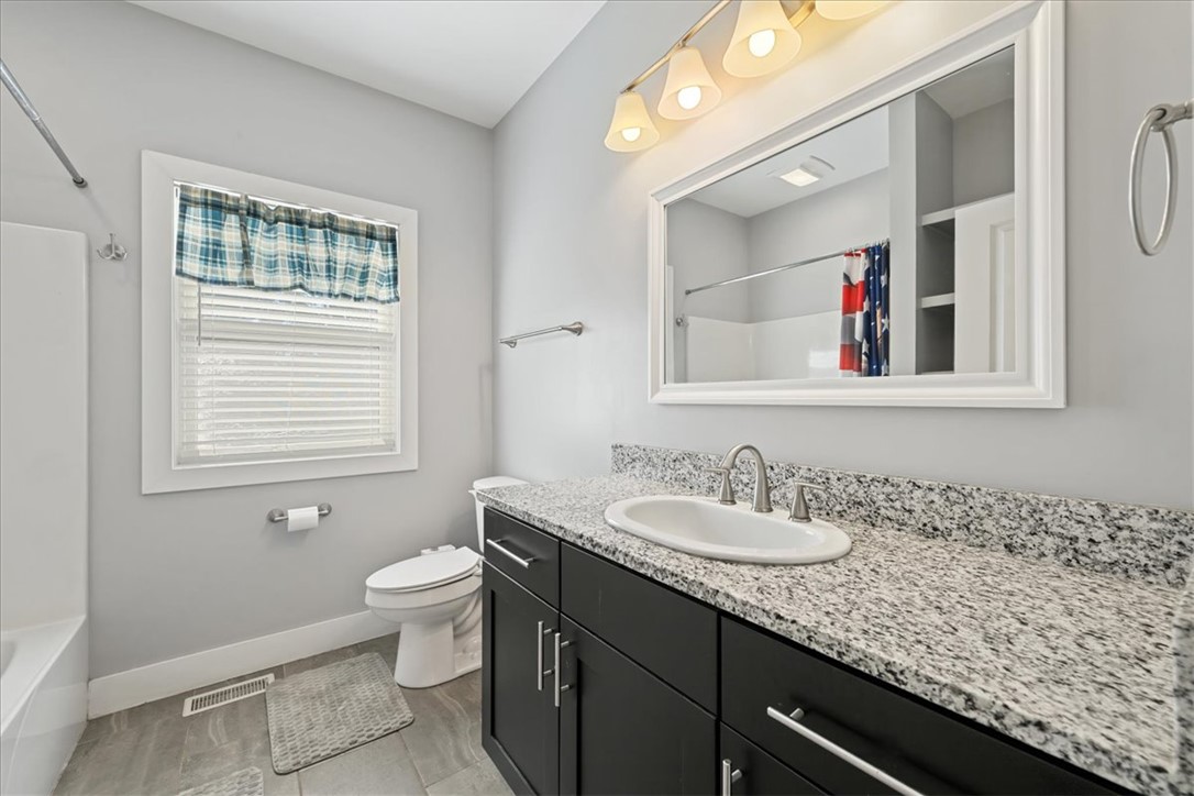 212 Winding Lane Seneca, SC 29672 - Photo 21 of 47 This bright bathroom features a spacious vanity with elegant granite countertops and sleek tile flooring.