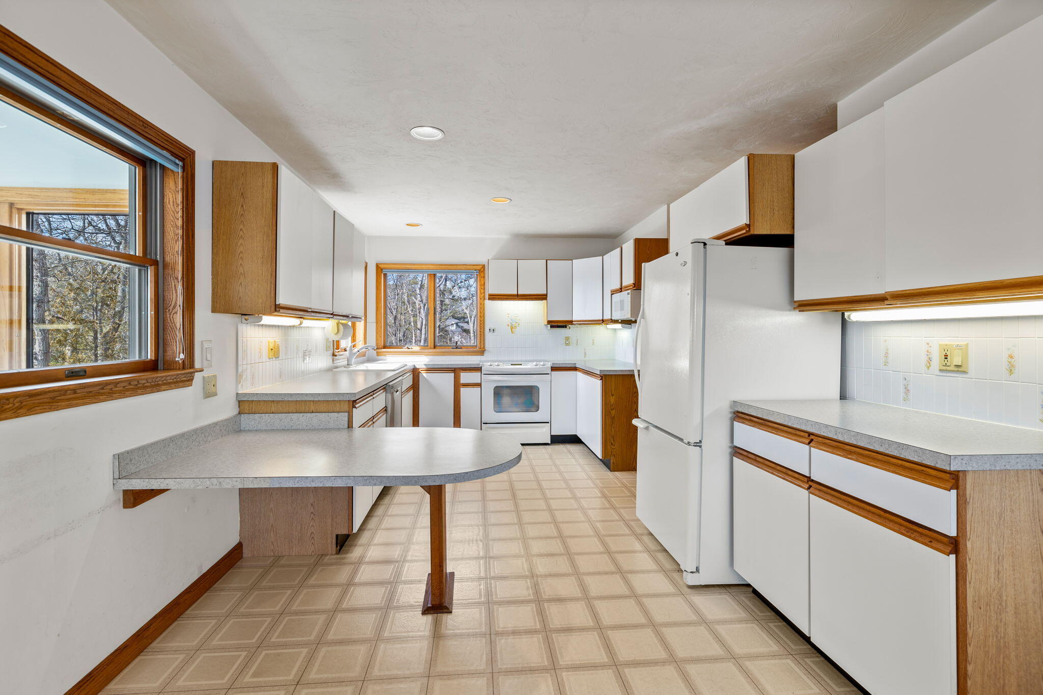 10 Circle Road East Falmouth, MA 02536 - Photo 22 of 65 a kitchen with stainless steel appliances a stove a sink and a refrigerator