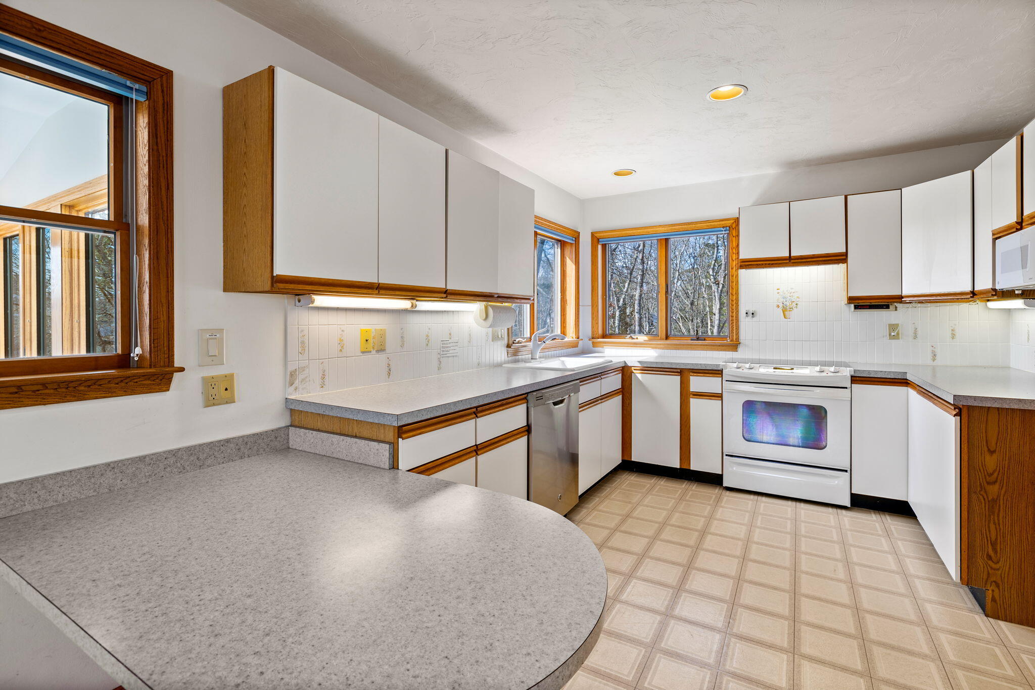 10 Circle Road East Falmouth, MA 02536 - Photo 23 of 65 a kitchen with a stove a sink and a refrigerator