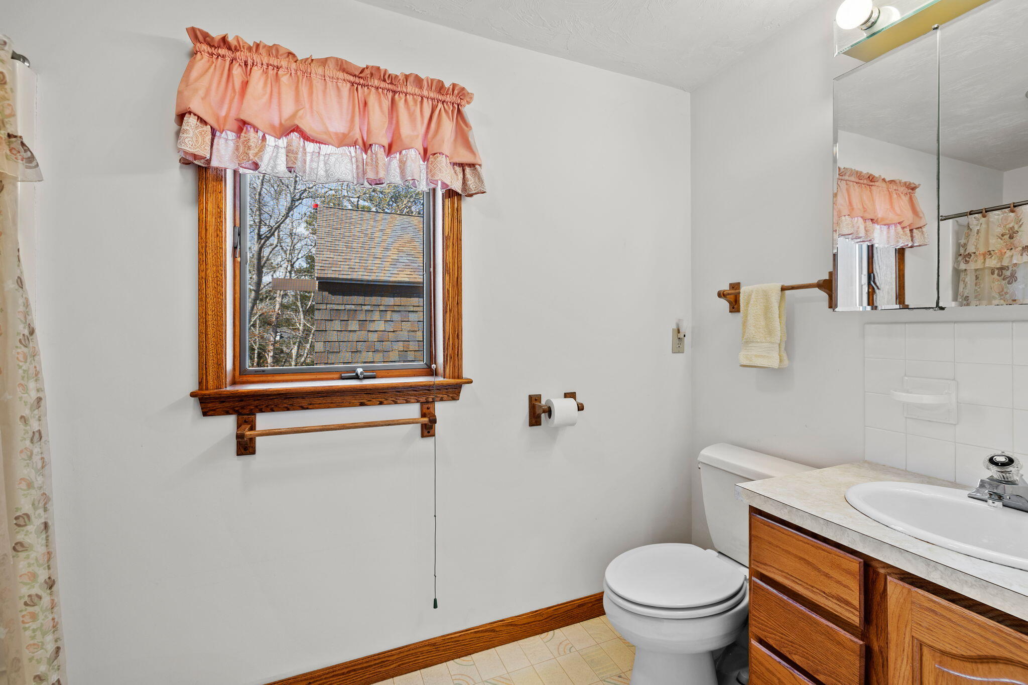 10 Circle Road East Falmouth, MA 02536 - Photo 31 of 65 a bathroom with a toilet sink and mirror