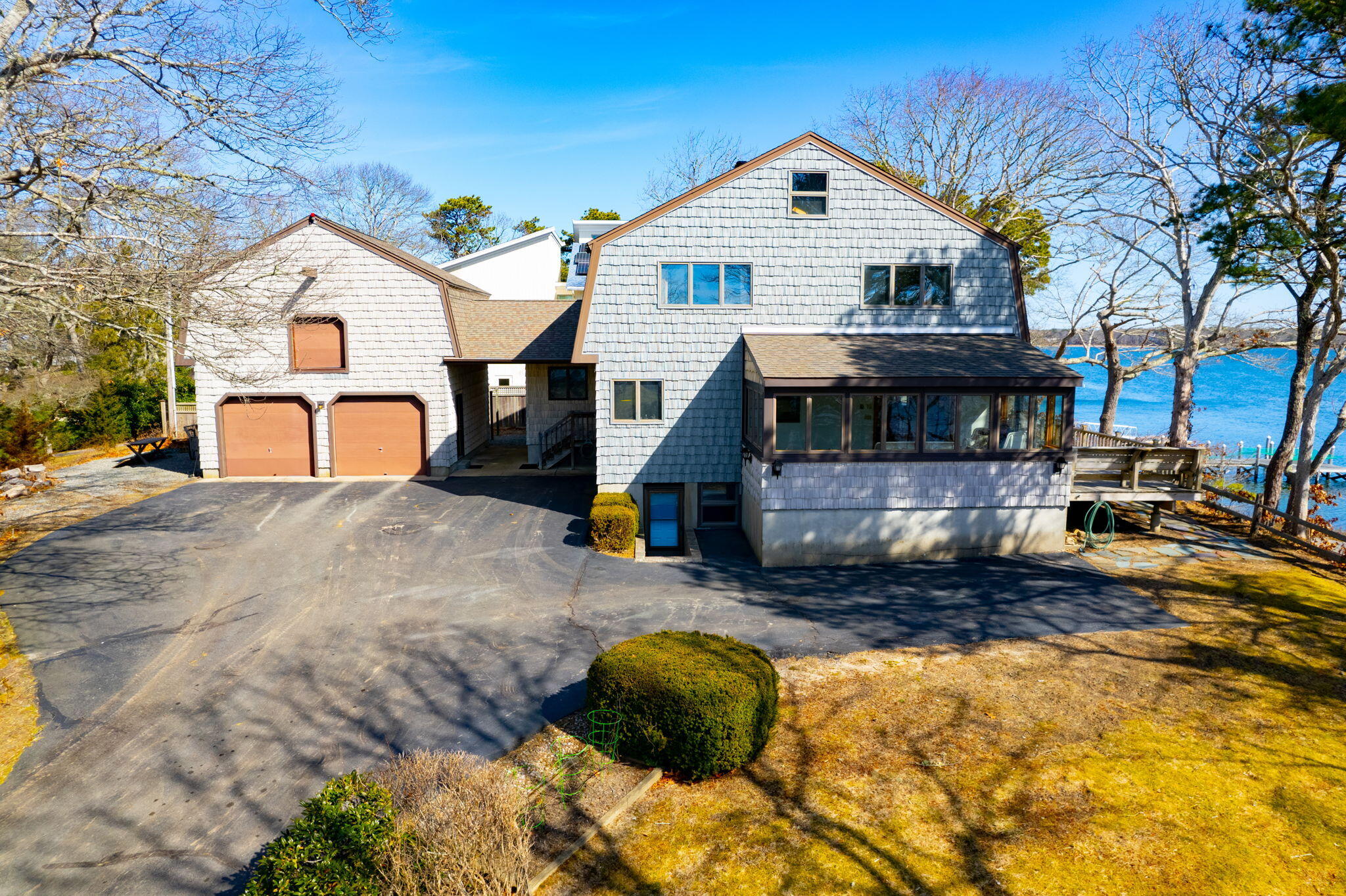 10 Circle Road East Falmouth, MA 02536 - Photo 53 of 65 a view of a white house with a yard covered with snow in the background