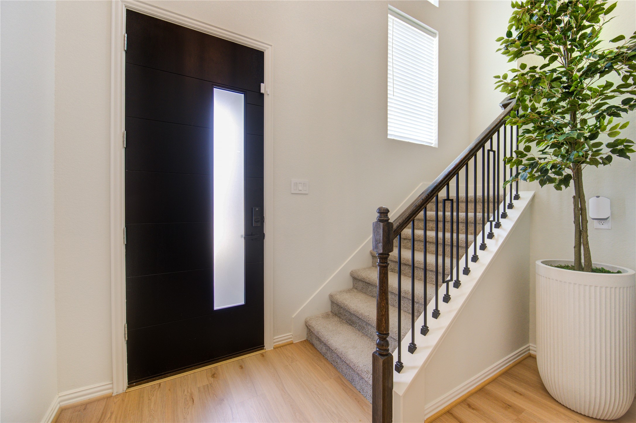12110 Fletching Stone Lane Houston, TX 77044 - Photo 11 of 50 a view of staircase with wooden floor and a potted plant