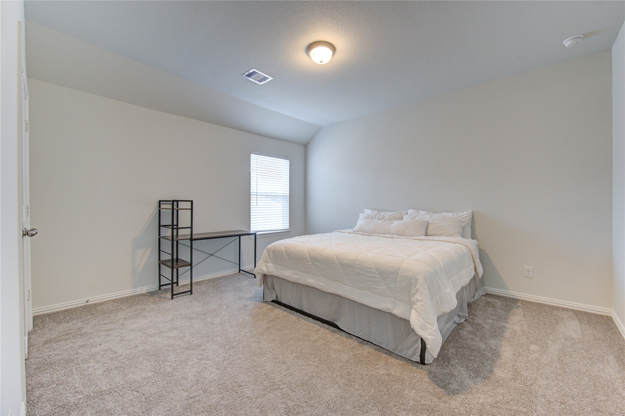 12110 Fletching Stone Lane Houston, TX 77044 - Photo 31 of 50 a spacious bedroom with a bed and a window