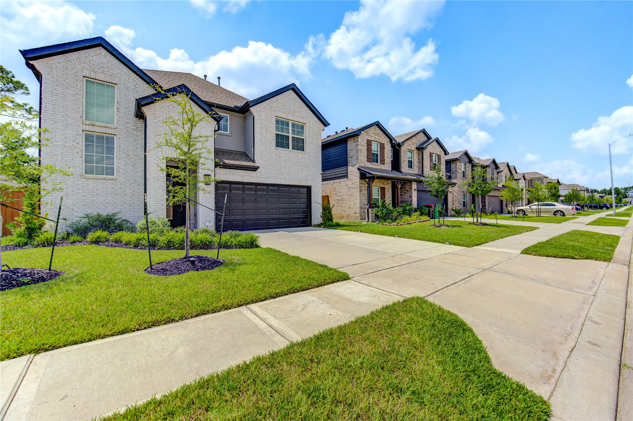 12110 Fletching Stone Lane Houston, TX 77044 - Photo 49 of 50 a front view of a house with a yard and garage