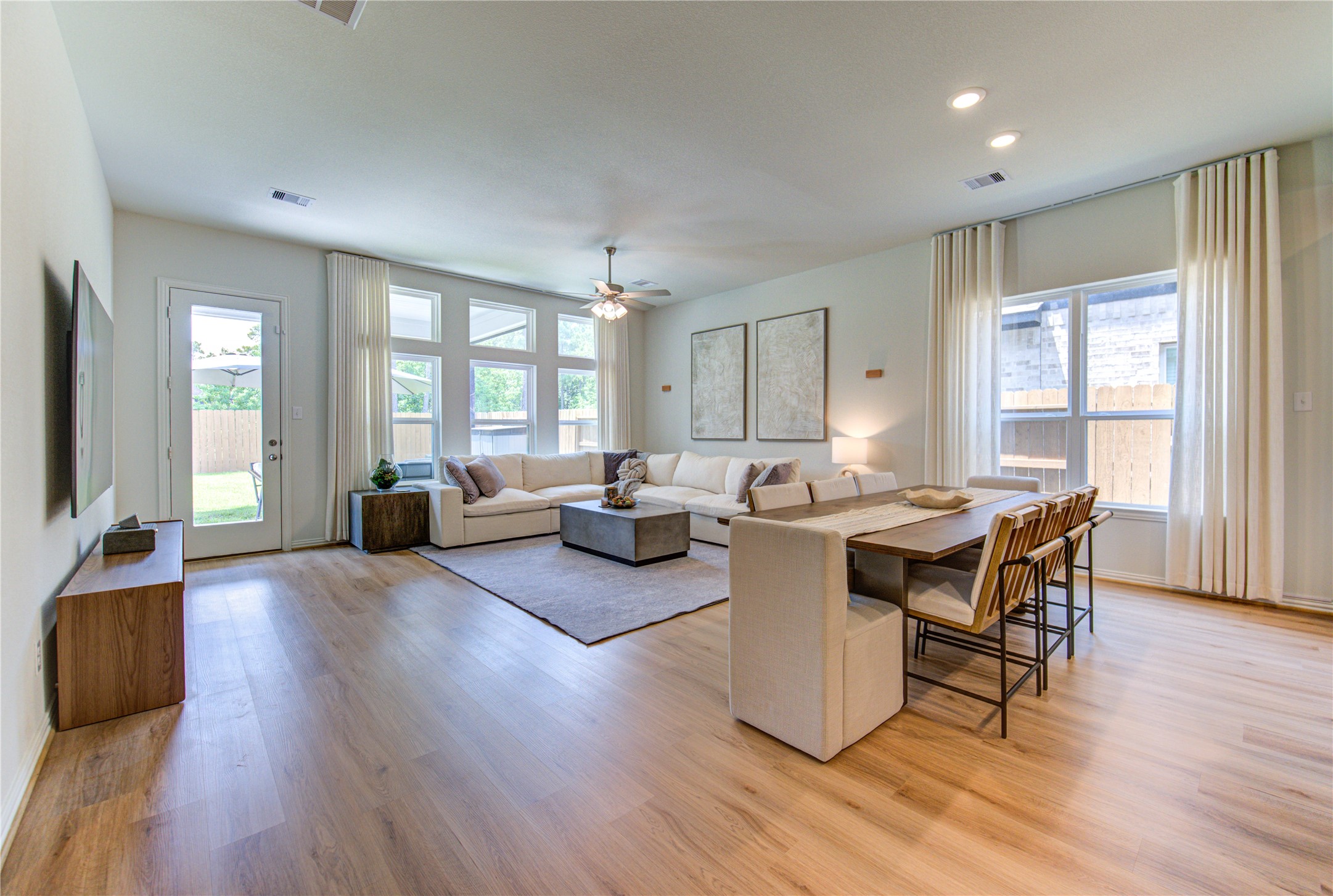 12110 Fletching Stone Lane Houston, TX 77044 - Photo 5 of 50 a living room with furniture a wooden floor and a large window