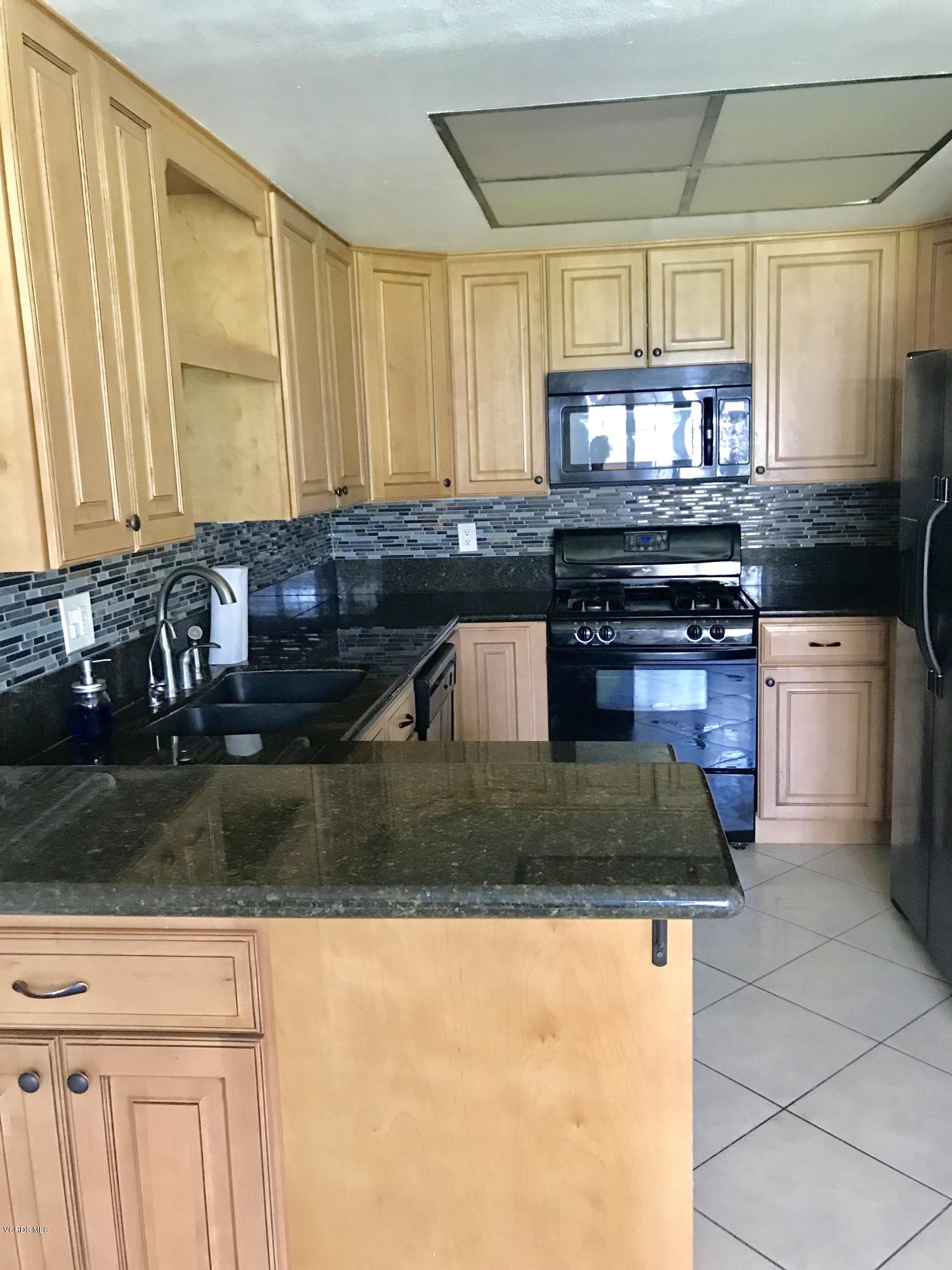 580 Spring Road, Unit 67 Moorpark, CA 93021 - Photo 22 of 43 a kitchen with a stove a sink and a cabinets