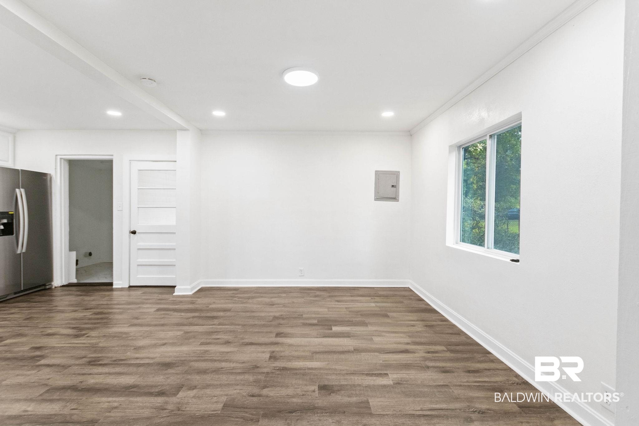 618 Pine Street Saraland, AL 36571 - Photo 14 of 41 Spare room featuring dark wood finished floors, recessed lighting, crown molding, and electric panel