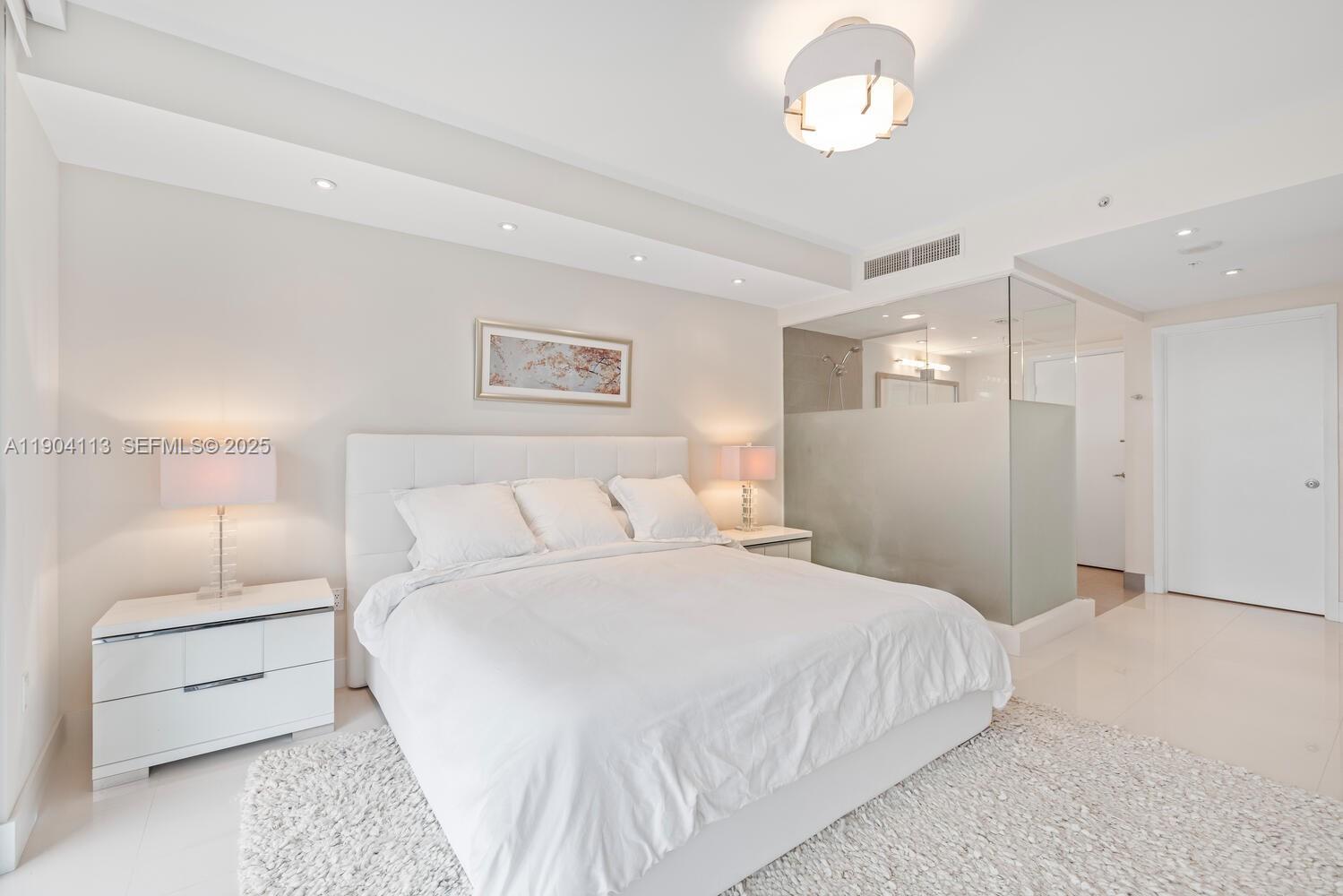 92 Southwest 3rd Street, Unit 310 Miami, FL 33130 - Photo 14 of 40 a bedroom with a bed and a night stand