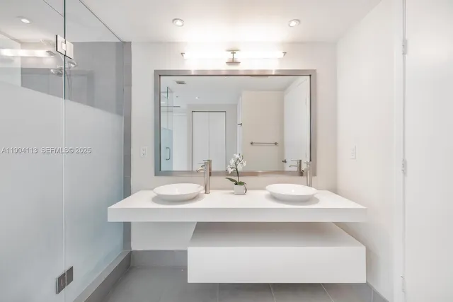 a bathroom with a sink vanity and a mirror