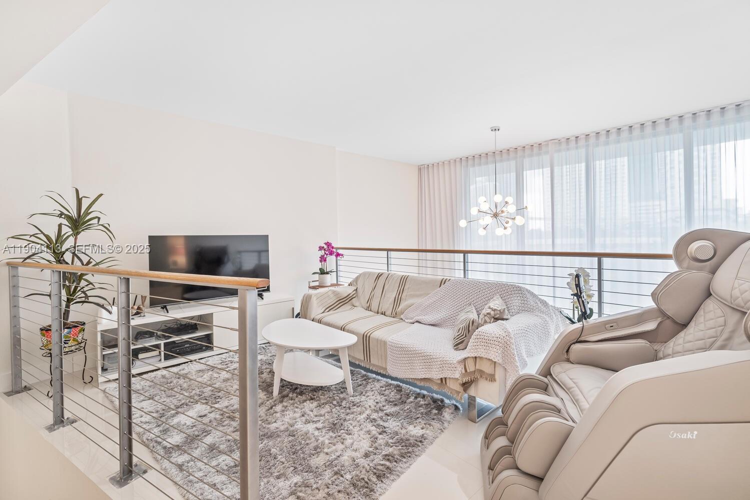 92 Southwest 3rd Street, Unit 310 Miami, FL 33130 - Photo 19 of 40 a living room with furniture and a flat screen tv