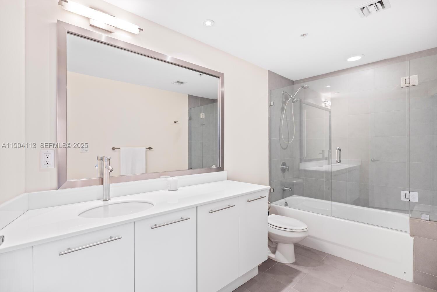 92 Southwest 3rd Street, Unit 310 Miami, FL 33130 - Photo 20 of 40 a bathroom with a sink a toilet and shower