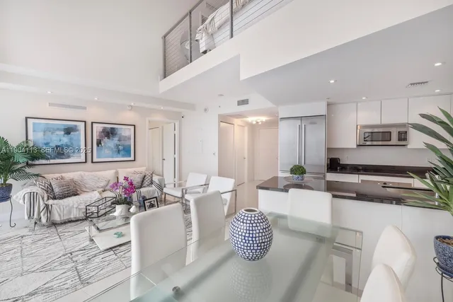 a living room with furniture and kitchen view