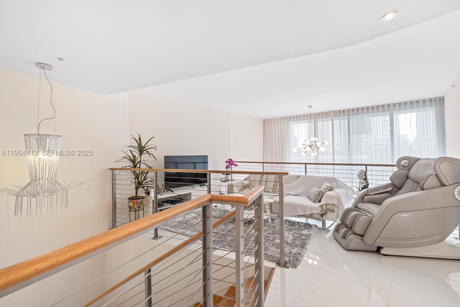 92 Southwest 3rd Street, Unit 310 Miami, FL 33130 - Photo 21 of 40 a living room with furniture and a flat screen tv