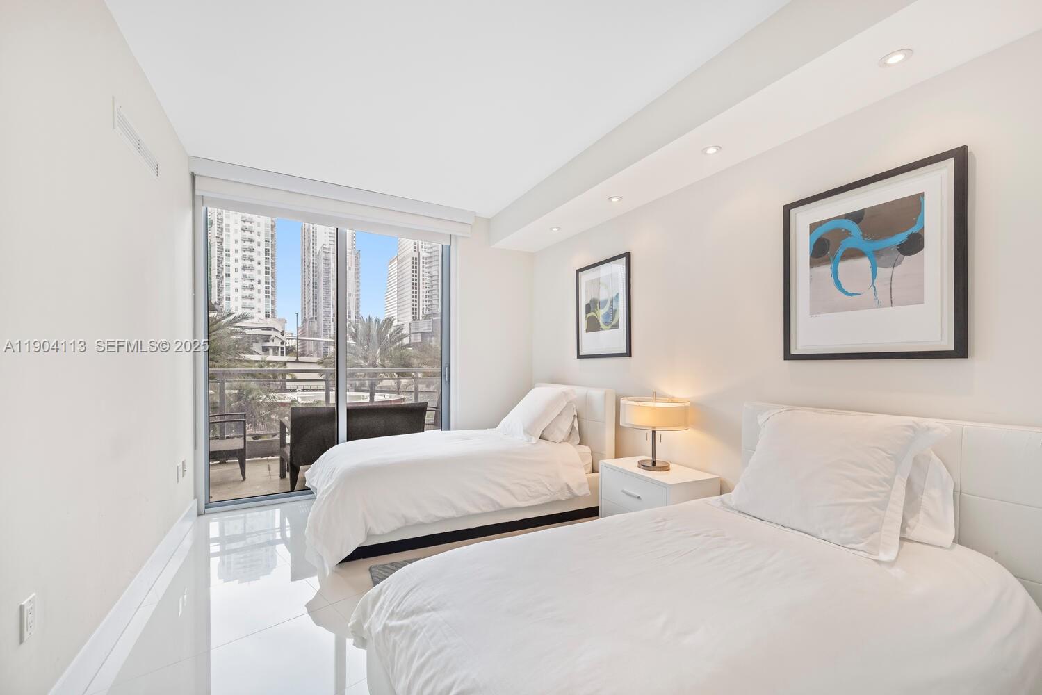 92 Southwest 3rd Street, Unit 310 Miami, FL 33130 - Photo 24 of 40 a bedroom with a large bed and a large window