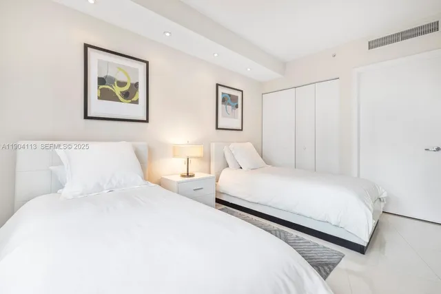 a bedroom with a bed and a painting on the wall