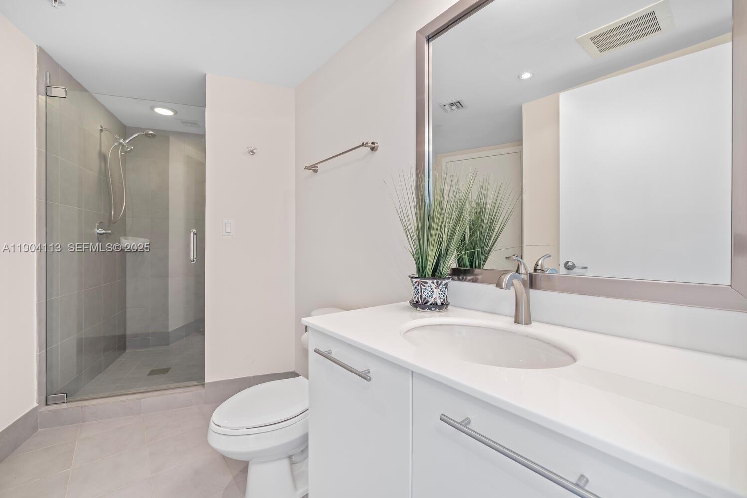 92 Southwest 3rd Street, Unit 310 Miami, FL 33130 - Photo 26 of 40 a bathroom with a sink toilet and shower