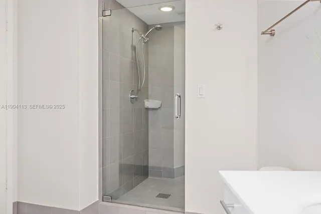 a bathroom with a shower and a sink
