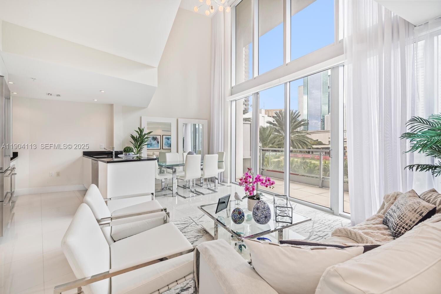 92 Southwest 3rd Street, Unit 310 Miami, FL 33130 - Photo 3 of 40 a living room with furniture and floor to ceiling windows