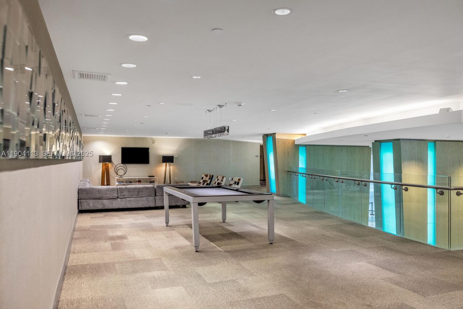 92 Southwest 3rd Street, Unit 310 Miami, FL 33130 - Photo 36 of 40 a living room with furniture and a flat screen tv