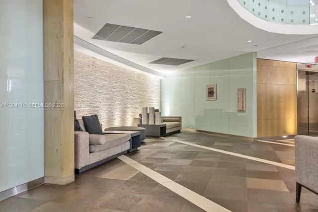 a view of a livingroom with furniture and staircase