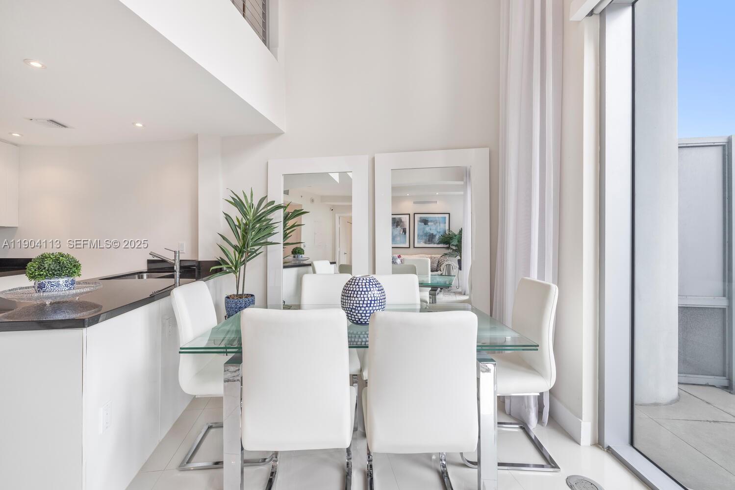 92 Southwest 3rd Street, Unit 310 Miami, FL 33130 - Photo 4 of 40 a dining room with furniture and wooden floor