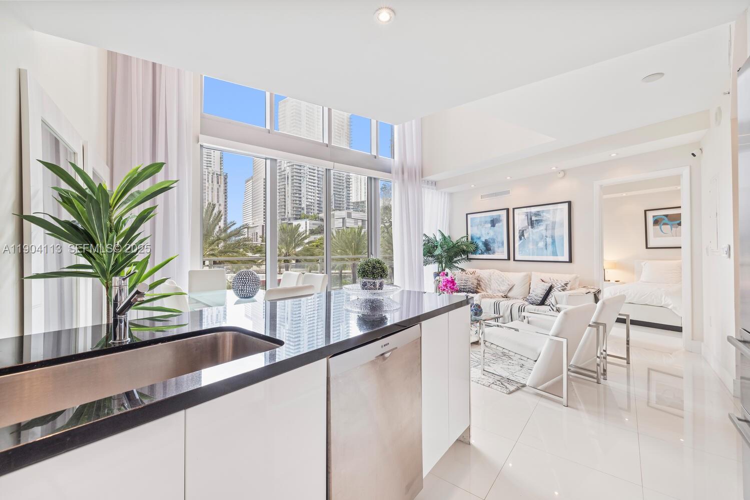 92 Southwest 3rd Street, Unit 310 Miami, FL 33130 - Photo 5 of 40 a living room with furniture and a potted plant