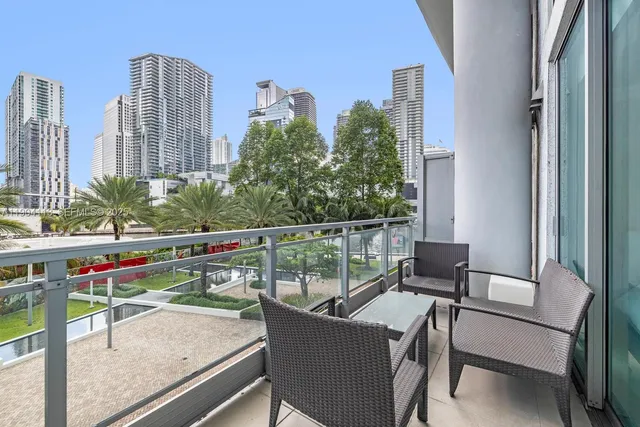 a view of balcony with wooden floor and outdoor seating