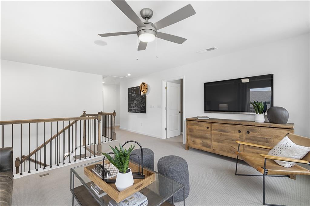 4387 Azalea Ridge Way Hoschton, GA 30548 - Photo 14 of 30 a living room with furniture and a flat screen tv