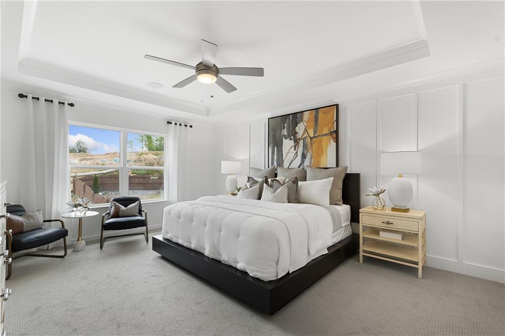 4387 Azalea Ridge Way Hoschton, GA 30548 - Photo 16 of 30 a spacious bedroom with a bed a table and large window