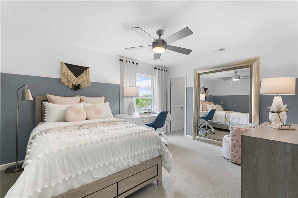 4387 Azalea Ridge Way Hoschton, GA 30548 - Photo 18 of 30 a bedroom with bed and a chandelier