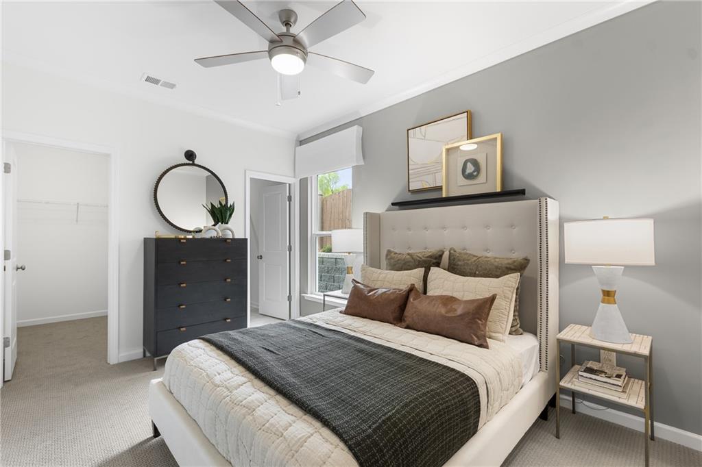 4387 Azalea Ridge Way Hoschton, GA 30548 - Photo 19 of 30 a bedroom with a bed and a painting on the wall