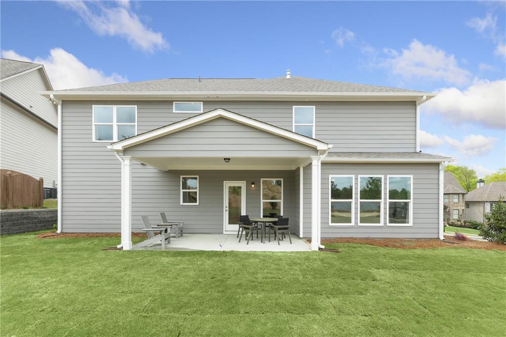 4387 Azalea Ridge Way Hoschton, GA 30548 - Photo 23 of 30 a front view of a house with a yard