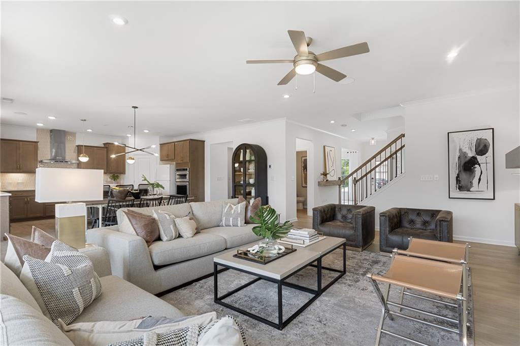 4387 Azalea Ridge Way Hoschton, GA 30548 - Photo 6 of 30 a living room with furniture kitchen view and a chandelier