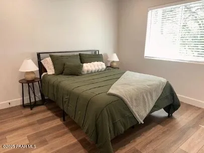 a bedroom with a bed and a night stand