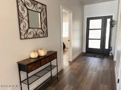 a view of an entryway with wooden floor