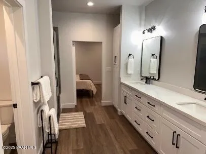 a bathroom with double vanity and a mirror