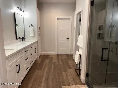 a bathroom with a double vanity sink and mirror
