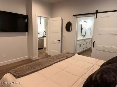 a bedroom with a bed a mirror and dresser