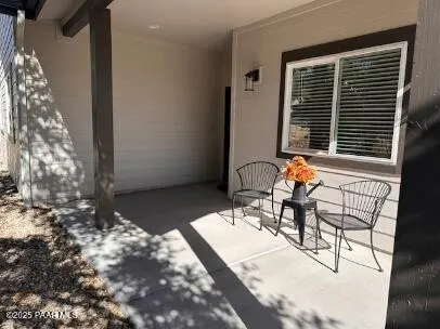 a view of a patio with table and chairs and potted plants