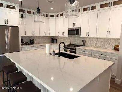a kitchen with stainless steel appliances a stove sink microwave and cabinets