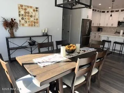 a dining room with furniture and wooden floor